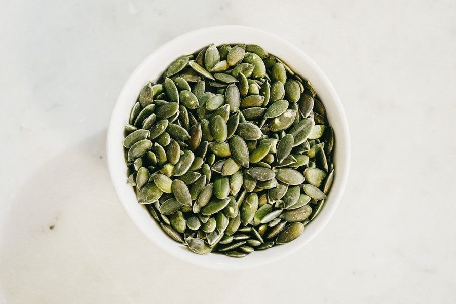 Bowl of green pumpkin seeds, a natural source of magnesium for sleep
