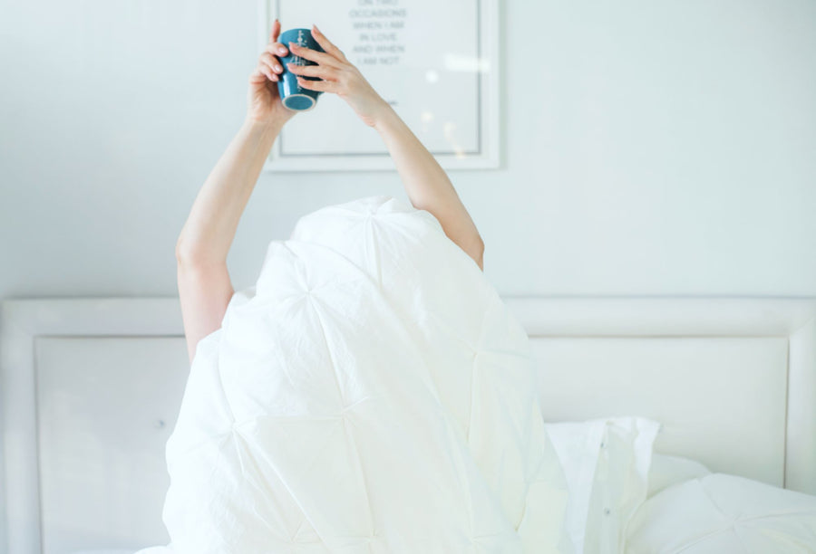 Relaxed morning in bed with a cup of coffee, supplements built for real life