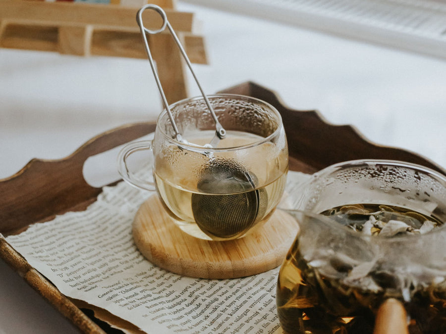 Glass teacups with a tea infuser, natural ingredients that improve sleep quality