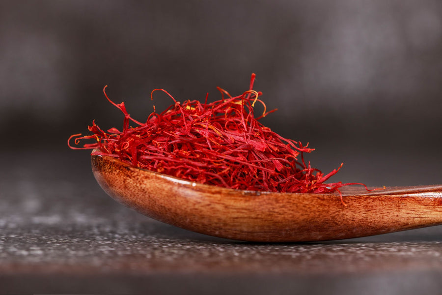 Saffron threads in a wooden spoon, saffron extract for mood and cognitive support