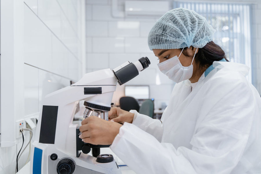 Scientist working at a microscope, the research behind FOOON supplements