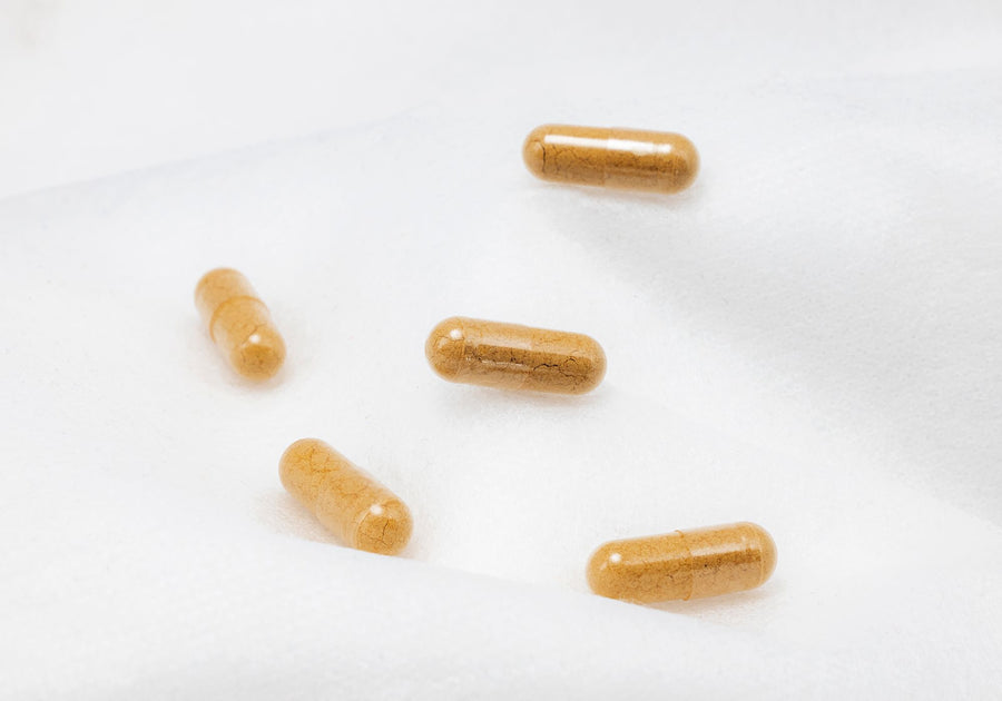 Brown supplement capsules on a white surface, why capsule form matters