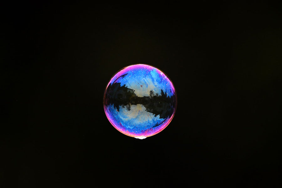 Single floating bubble on a black background, what liposomes are and how they work